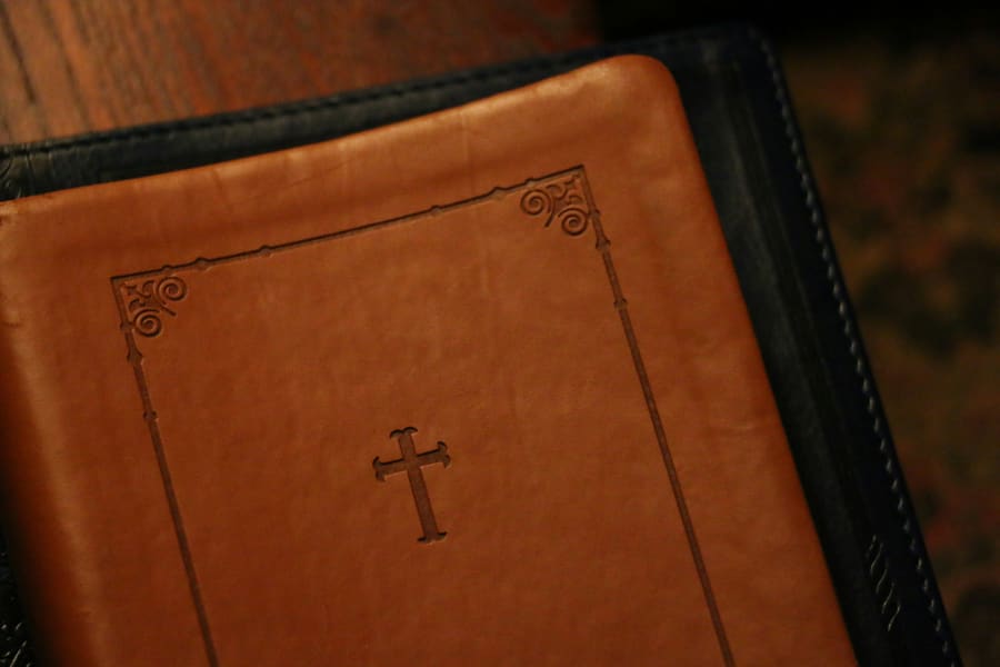 An embossed leather Bible with a cross on its cover.